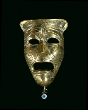 Tragic mask with incised decoration and attached glass eye (see also 85279-81)