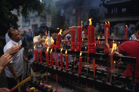 Religious worship in China: devotions in front of a temple.