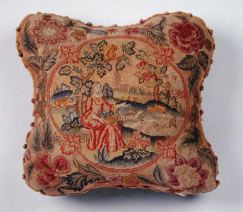 Cushion, embroidered in petit point, depicting a woman in a landscape (textile)