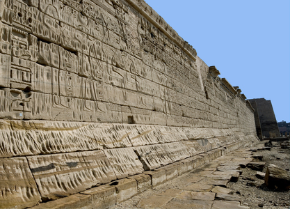 Egyptian antiquite: view of the walls of the western part. Funeral Temple of Ramses III (1187-1156 BC). Luxor, Medinet Habou, Egypt