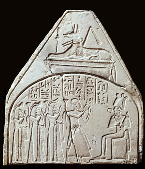 Egyptian antiquite: stele fragment representing the worship of the god Osiris. Above it is representing Anubis. Paris, Louvre Museum