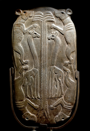 Cosmetic palette decorated with canidae and giraffe (Back view) (Schist bas relief, ca. 3500-3100 BC)