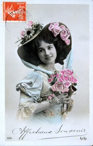 Young woman holding a bouquet of roses - postcard early 20th century.