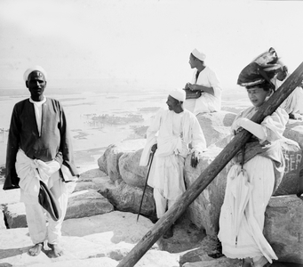 Egypt, Cairo: cruise on the Nile, tourists accompanied by their local guides are served the tea on the top of the Pyramid Cheops, flooded Nile Valley, 1900