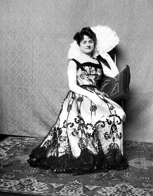 France: A young woman poses in a fancy dress and a fan in his hand, 1895