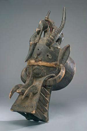Helmet mask of the Senufo people (Cote d'Ivoire) (wood, cotton, feathers, iron, leather & pigment)