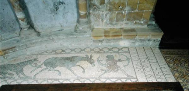 Pavement depicting a hunter being followed by a donkey and a dog (mosaic)