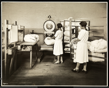 Two African American women weighing bags of laundry at the Carolyn Laundry at 111 East 128th Street, East Harlem, New York, 1928 (silver gelatin print)