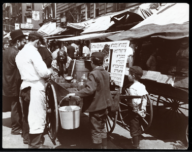 View of children buying drinks from a peddler on Hester Street, New York, 1898 (silver gelatin print)