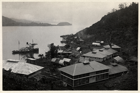View of a group of buildings near a large body of water during the construction of the Panama Canal, 1912 or 1913 (silver gelatin print)