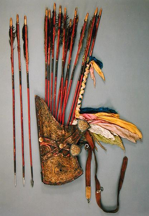 Flat quiver with openwork mounts and eleven arrows, iron points and painted reed shafts, one bound with colour scarves (leather)