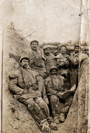 First World War (1914-1918): Hairy soldiers in winter dress in a trench in 1916-1917. They wear sheepskin jackets and a gas mask.