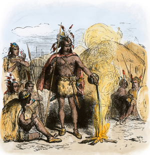Indian ceremony of a tribe from the south east, involving a ritual of fire, circa 1500. In the centre of a tent village, the sorcerer poured liquid on flames, under the watchful eyes of the warriors of his community. Lithography, 19th century.