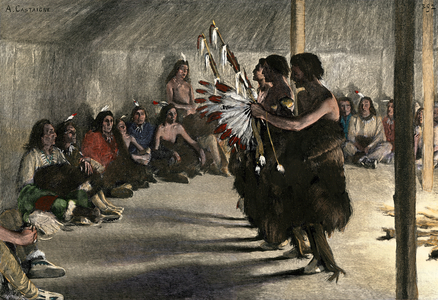 Indian ceremony. The dancers performing the ritual dance in a circle around the fire, in the tent of the Great Plains tribal gathering (USA). Lithograph of A. Castaigne, after a 19th century illustration.