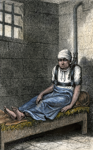 Norris chained up in his cell for 12 years. New York, 1870s. Representation of the treatment of the mentally ill in prison in the United States at the end of the 19th century. Colour engraving after a 19th century illustration.