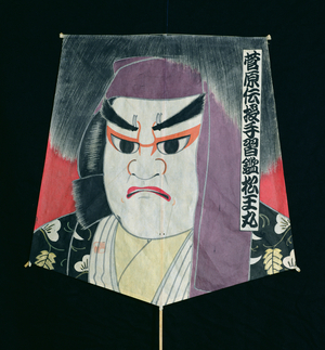 Five-sided kite depicting a frowning man, with calligraphy down the right-hand side, Japanese, 20th century (paper and bamboo)