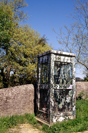 Telephonic booth in the French countryside, years 80-90 (between 1980 and 1990) - The aluminium glass structure was decoree with trompe-l'oeil foliage by an amateur artist - telephone, communication, 80 years - Photo Patrice Cartier -