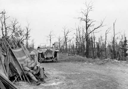 First World War 14-18 (1914-1918): On the edge of a road devastated by the bombing, a French soldier watches over a load of stretchers ready to be transported to the front in an ambulance to rescue the wounded. Anonymous period photography on glass plate -