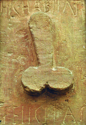Plaque with phallus surrounded by Latin writings “Hic habitat felicitas” (Here inhabits felicite). Travertine painted in red, Low relief. From Pompei, Naples (bas-relief)