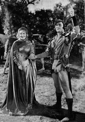 Errol Flynn (Robin) and Olivia De Havilland (Marianne-Lady Marian) in the film “The Adventures of Robin Hood, Michael Curtiz & William Kighley, 1938). Photograph published on the last cover of the French magazine “” Mon film”” in February 1948.