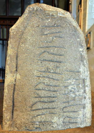 Killaloe: The Ogham stone (circa 1000 A.D.), probably carved by a Viking converted to Christianity, bears two inscription, one in old Gaelic writing and one in runes The Runes read “” Thorgrimr carved this cross””, the Ogham reads “” A blessing on Thorgrimr””” - stone gravee of an mil (an mille) discovered in 1916 in Killaloe (Ireland) - probably engraved by a Viking converted to Christianity, it has the particularity of carrying two inscriptions, one in runes and the other in ancient Gaelic (Celtic Oghamic script) - Nordic civilization - Celts - Photo Patrice Cartier -