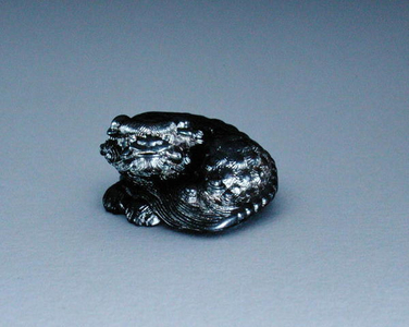 Netsuke, depicting a shishi, c.1850 (black persimmon wood)