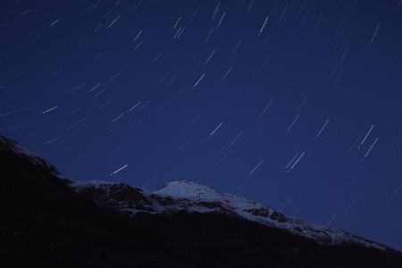 Star line on the Vanoise Massif - Star trails above Grand Roc Noir - In the foreground, the Grand Roc - Noir (3587m), in the Vanoise National Park (Haute - Maurienne). Starry sky above the Alps. Foreground is Grand Roc - Black (3587m), in Savoie, France