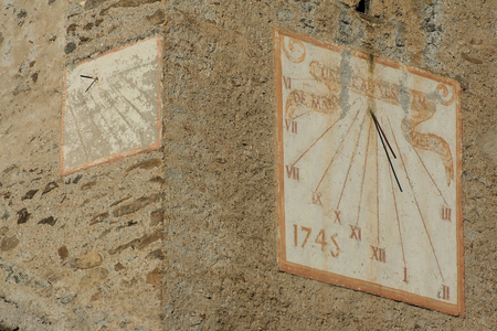 Sundials - Sundials in France - The sundials of the church of Lanslevillard (Savoie). The church dates from the 13th century. On the west side of the bell tower, a small dial, very erased, indicates the hours of the afternoon. Old sundials (1745) on the 12th century church of Lanslevillard, Savoie, France