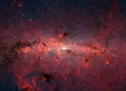 The galactic center seen by Spitzer Space Telescope - The galactic center region seen by Spitzer satellite. The area photographed extends over 890 light-years and over 640 light-years high. In visible light, this area is hidden by a large amount of interstellar dust. This picture in false colors shows the old and cold stars in blue, and the red regions the hot and massive stars. Dark and bright filamentous clouds are star-forming regions. The brightest area in the center of the image is the center of our galaxy which houses a supermassive black hole. This infrared image from Nasa's Spitzer Space Telescope shows hundreds of thousands of stars crowded into the swirling core of our spiral Milky Way galaxy. In visible-light pictures, this region cannot be seen at all because dust lying between Earth and the galactic center blocks our view. In this false-color picture, old and cool stars are blue, while dust features lit up by blazing hot, massive stars are shown in a reddish hue. Both bright and dark filamentary clouds can be seen, many of which harbor stellar nurseries. The plane of the Milky Way's flat disk is apparent as the main, horizontal band of clouds. The brightest white spot in the middle is the very center of the galaxy, which also marks the site of a supermassive black hole. The region pictured here is immense, with a horizontal span of 890 light-years and a vertical span of 640 light-years. Earth is located 26,000 light-years away, out in one of the Milky Way's spiral arms. Though most of the objects seen in this image are located at the galactic center, the features above and below the galactic plane tend to lie closer to Earth. This image is a mosaic of thousands of short exposures taken by Spitzer's Infrared Array Camera. The entire region was imaged in less than 16 hours