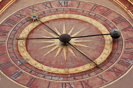 Dial of the Tower of the Clock - Auxerre - Clock on the clock tower in Auxerre - Clock with dials of the Tower of the Clock in Auxerre. This public clock was built in 1469 by a master watchmaker named Jean. It operated until 1812. The present mechanism dates back to 1817. The clock consists of two identical dials, one to the east (photo), the other to the west. The dials are divided into 24 hours: from noon to midnight, and from midnight to noon. A needle on which the Sun is depicted indicates the hours of the day. The second hand carries a globe with half black and half gold. This globe indicates the phases of the Moon. This needle indicates the lunar day, which is 24h49min. The stars pass to the Meridian (towards the south) when their image is at the top of the dial, on the number XII. Clock on the 15th century clock tower in Auxerre