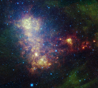 Irregular Galaxy of the Little Magellan Cloud (NGC 292) - The Small Magellanic Cloud - The galaxy of the Little Magellan Cloud is about 240,000 light years from Earth in the southern constellation of Toucan. It's one of the closest galaxies of the Lactee Way. Infrared image obtained by Spitzer space telescope. This infrared portrait of the Small Magellanic Cloud, taken by Nasa's Spitzer Space Telescope, reveals the stars and dust in this galaxy as never seen before. The Small Magellanic Cloud is a nearby satellite galaxy to our Milky Way galaxy, approximately 200,000 light - years away. The image shows the main body of the Small Magellanic Cloud, which is comprised of the “” bar”” on the left and a “” wing”” extending to the right. The bar contains both old stars (in blue) and young stars lighting up their natal dust (green/red). The wing mainly contains young stars. In addition, the image contains a galactic globular cluster in the lower left (blue cluster of stars) and emission from dust in our own galaxy (green in the upper right and lower right corners). This image was captured by Spitzer's infrared array camera and multiband imaging photometer (blue is 3.6 - micron light; green is 8.0 microns; and red is combination of 24 -, 70 - and 160 - micron light). The blue color mainly traces old stars. The green color traces emission from organic dust grains (mainly polycyclic aromatic hydrocarbons). The red traces emission from larger, cooler dust grains