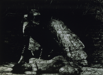 Raven bending down over lying woman