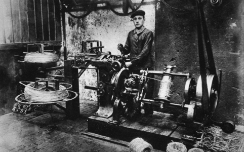 The Manufacture of Barbed Wire- the Machine for fixing on the Barbs at its work, from 'The Illustrated War News' (sepia photo)