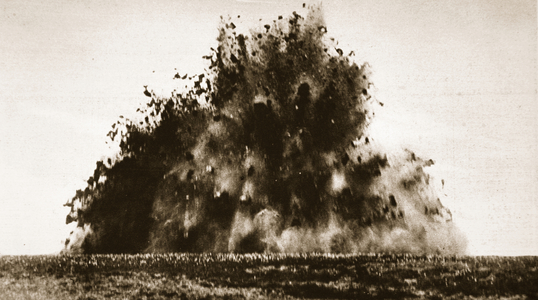 A large mine being detonated in French territory during World War One (b/w photo)