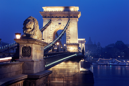 Lion gates on Chain Bridge over Danube River in Budapest at night