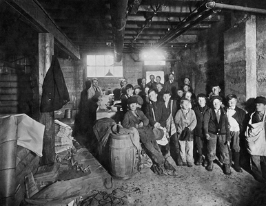 United States: 1912
Street vendor boys picking up their papers to sell in the Gazette mail room.