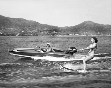 Acapulco, Mexico: 1955 - A woman water skis on the bay with another speedboat running along beside her