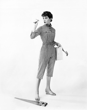 United States: c. 1957
A young woman in fashionable cotton coveralls prepares for some household repairs.