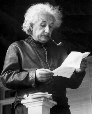 Albert Einstein reading a letter, USA, 1938 (b/w photo)