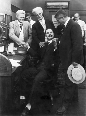 New York, New York: c. 1917
Sign on the door says ""Merrill Broker"", and possibly Charles Merrill. The photograph looks like a film still, but was used in a book on Wall Street and the author identified the seated man as Charles Merrill.....