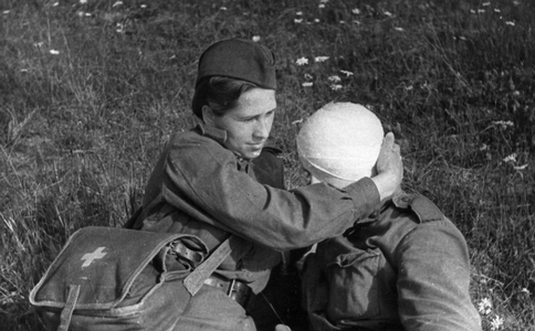 World War 2. Nurse's aid Mikutite of a Lithuanian Red Army unit tending to a wounded soldier. July 1943.