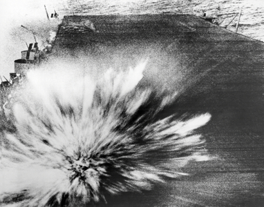 Pacific Ocean: October 15, 1945.
A Japanese bomb explodes on the flight deck of the USS Enterprise, killing the photographer, Phom 3/c Robert Read, but the film survived.