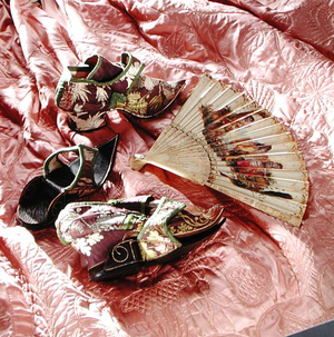 Items from the costume collection: Matching brocade shoes and clogs, 1720-30; An Italian fan with ivory guards, 1740's; and A pink quilted petticoat, 1740's (photo)