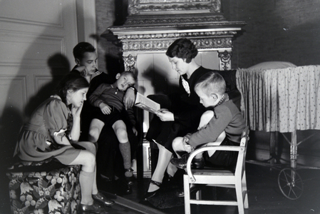 Members of an extended family reading a book together, Germany 1930s
