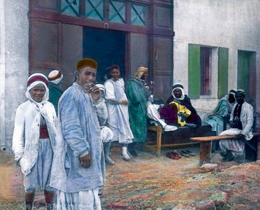 Algeria - Men sitting in a little coffee house in the city of Oran. Carl Simon Archive, image date circa 1920