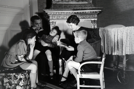 Members of an extended family reading a book together, Germany 1930s