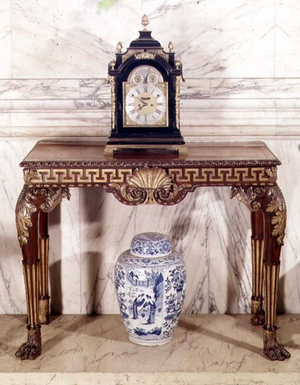 Carved and parcel-gilt mahogany side-table, clock by Rimbault; Delft jar, c.1700