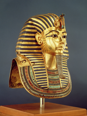 The funerary mask of Tutankhamun (c.1370-1352 BC) New Kingdom, c.1336-1327 BC (gold inlaid with semi-precious stones) (see also 228800)