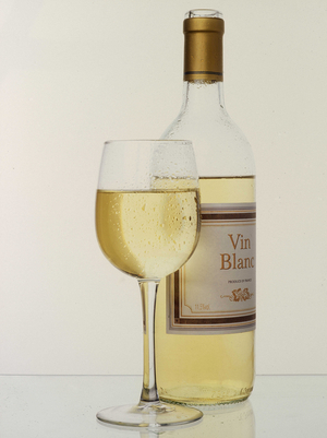 Still life: glass and bottle of white wine.