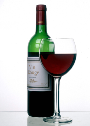 Bottle and glass of French red wine.
